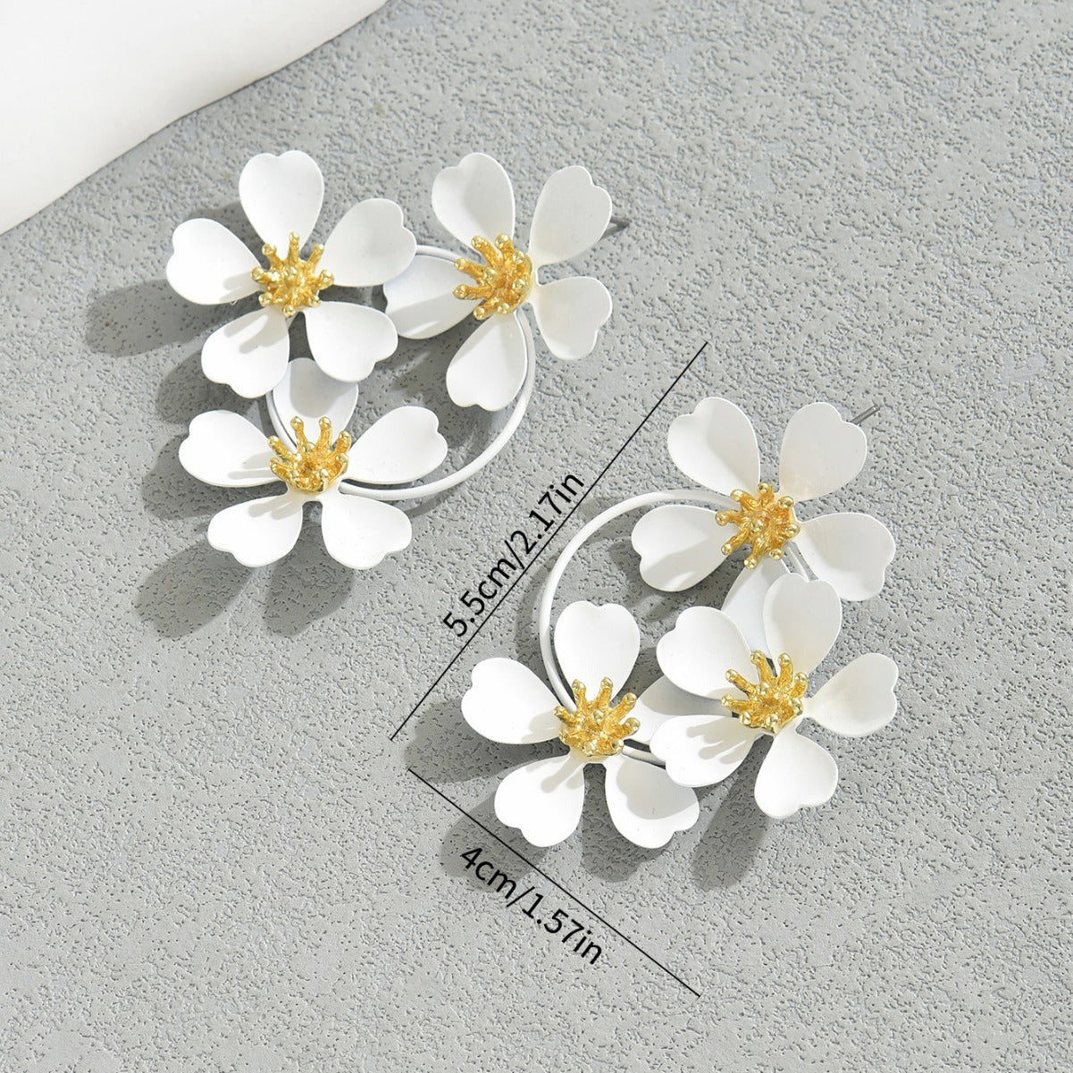 Calm white sunflower earrings with white petals and gold centers measuring 5.5cm by 4cm