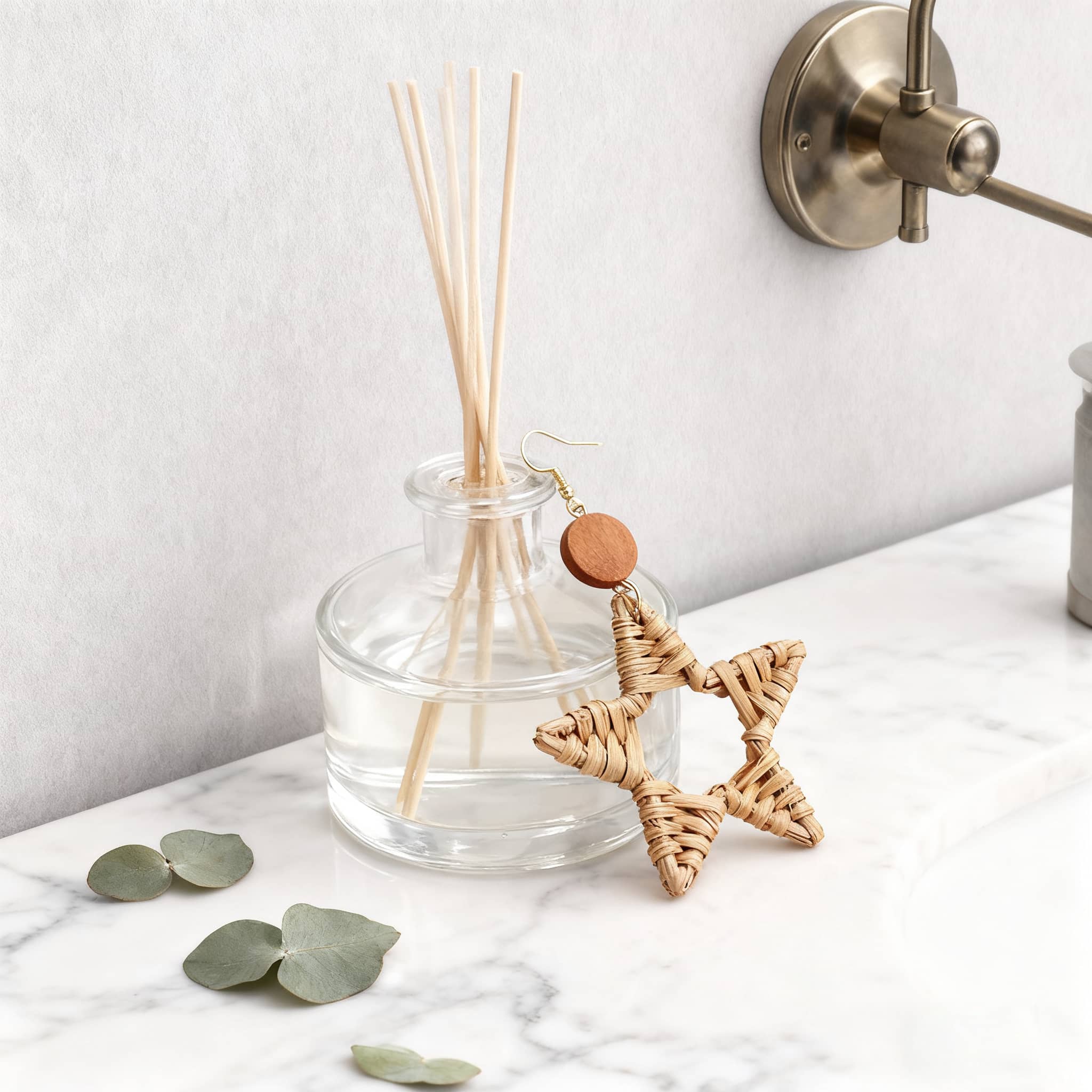 Wood and bamboo star earrings featuring a woven design with a circular wood accent