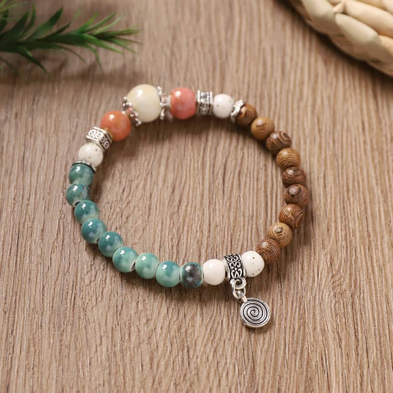 Wood and ceramic mindful bracelet featuring colorful beads and a charm for relaxation and balance