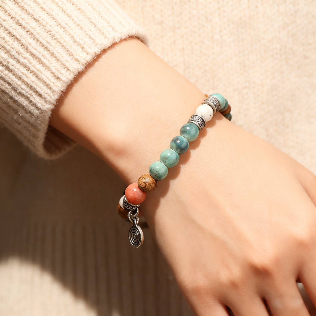 5 Senses wood and ceramic mindful bracelet featuring butterfly design with purple and white beads