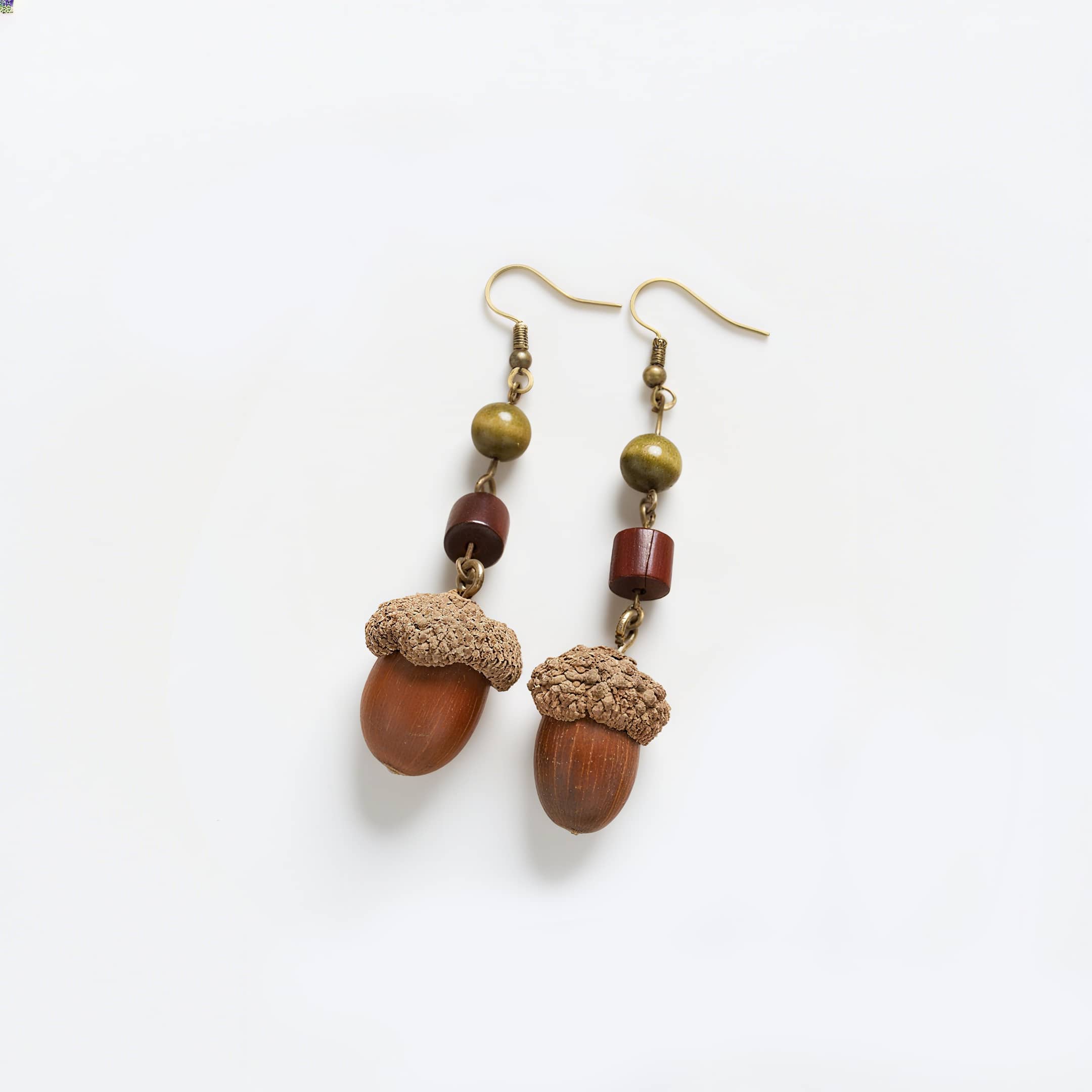 Handcrafted wooden acorn earrings with natural textures and earthy colors for a unique accessory