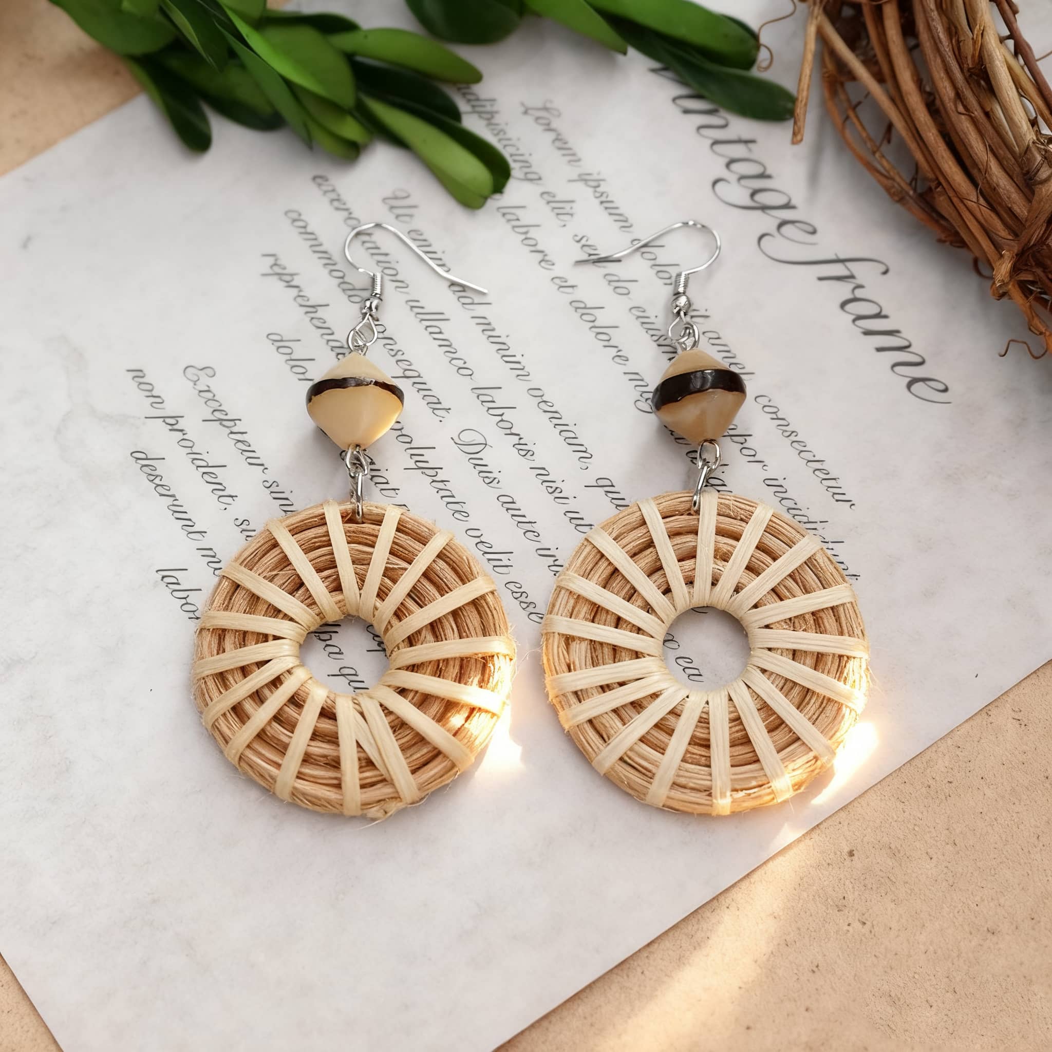 Handcrafted woven bamboo hoop earrings with stylish bead accents for a natural look